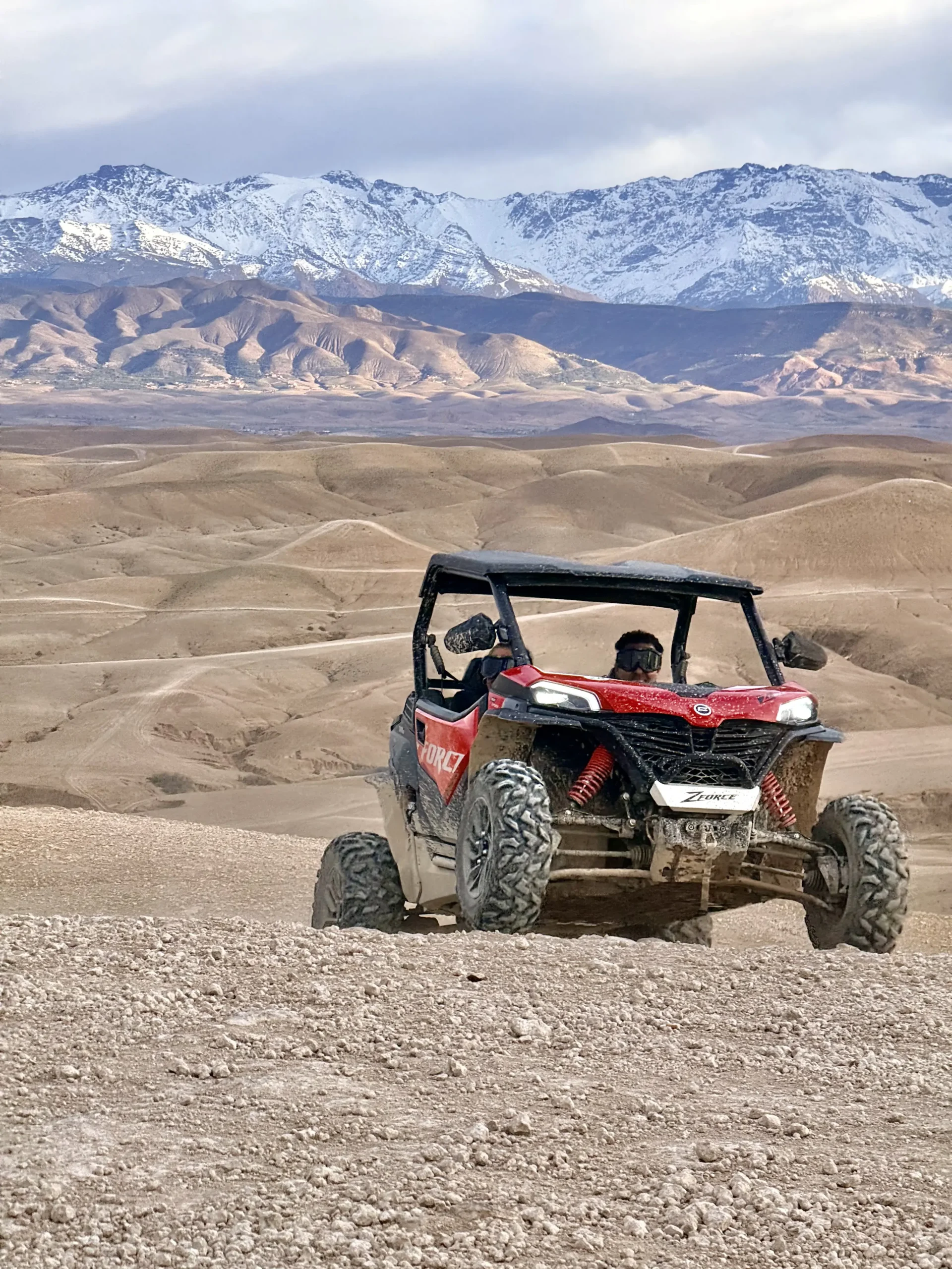 Two-seater buggy on an Agafay track with the Atlas Mountains behind